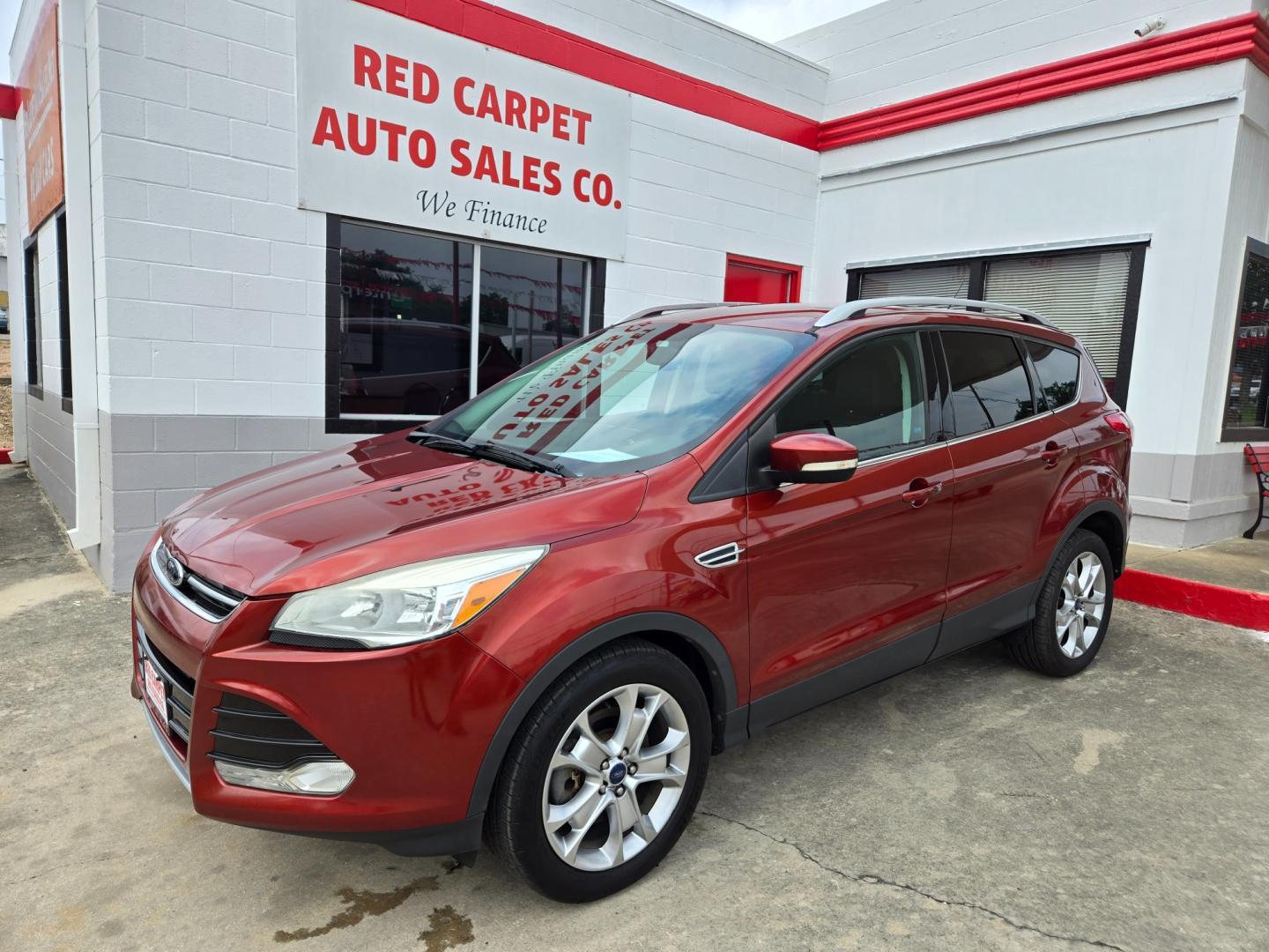 2014 Orange Ford Escape Titanium 4WD (1FMCU9JX7EU) with an 1.6L L4 DOHC 16V engine, 6-Speed Automatic transmission, located at 503 West Court, Seguin, TX, 78155, (830) 379-3373, 29.568621, -97.969803 - Photo#0